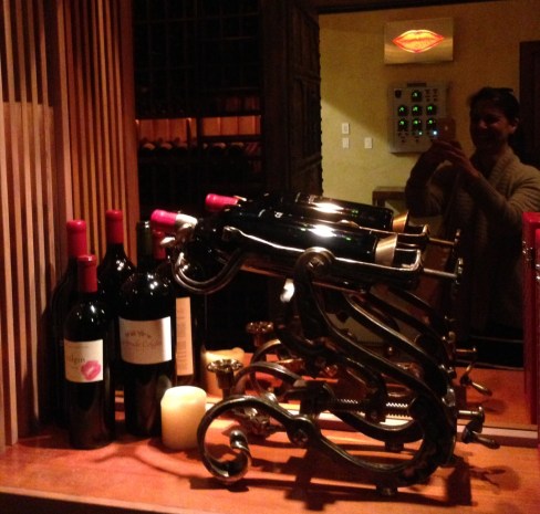 her lips on the bottle at the left, the art in the mirror