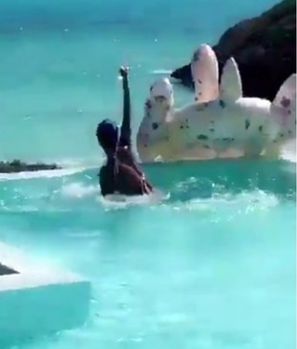 Grainy pic, but that's because Rihanna fell off her swan float but SAVED HER ROSÉ in the process. All the love....